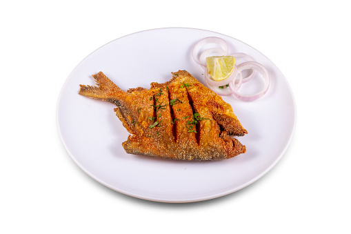 Pomfret fry Served in a plate over white background. Selective focus.