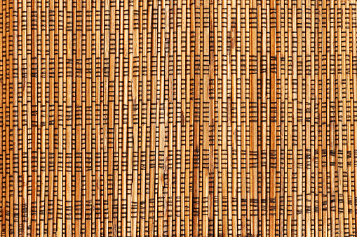 Bamboo cane matting, natural background, vertical texture close-up