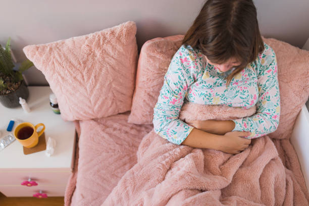 Aerial view of a teenage girl having stomachache stock photo