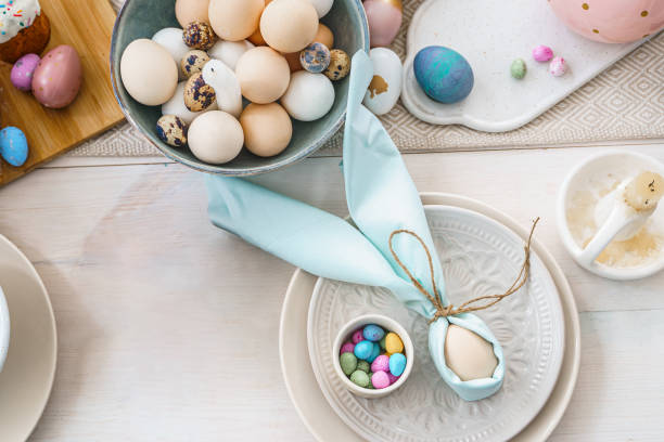istock Table decoration for Easter celebration in kitchen.Tablescape for Easter holiday at home.Family religious traditional festive christianity,catholic meal food.Pop color eggs,cake,fun bunny,candy sweet 1427327662