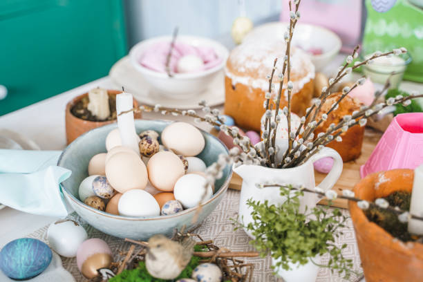 istock Table decoration for Easter celebration in kitchen.Tablescape for Easter holiday at home.Family religious traditional festive christianity,catholic meal food.Pop color eggs,cake,fun bunny,candy sweet 1427327712