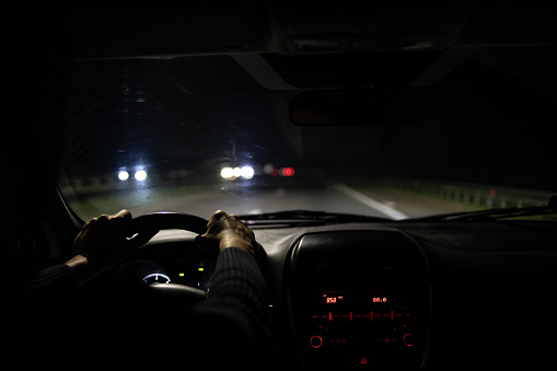 Car moving on highway at night