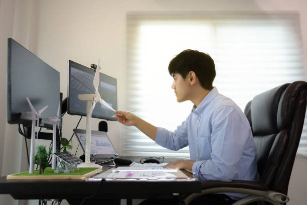 istock Young smart design engineer design Green energy system , freelance engineer work at home office ,  engineer working on the wind turbines project 1427332579