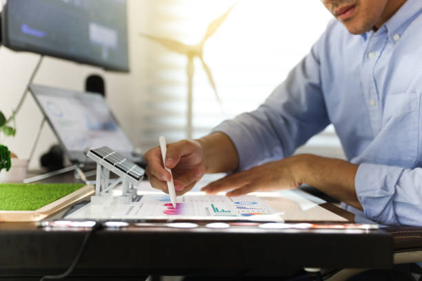 istock Young smart design engineer design Green energy system , freelance engineer work at home office ,  engineer working on the wind turbines project 1427332589