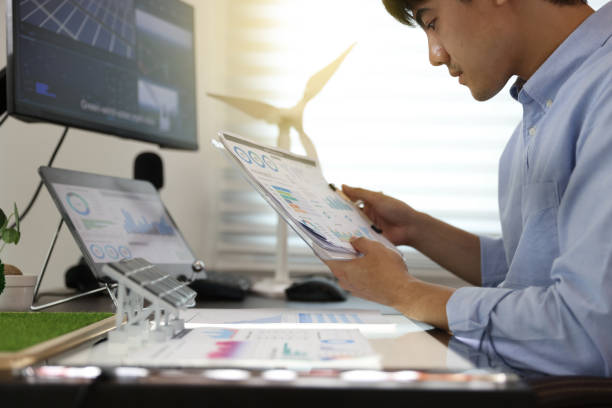 istock Young smart design engineer design Green energy system , freelance engineer work at home office ,  engineer working on the wind turbines project 1427332594