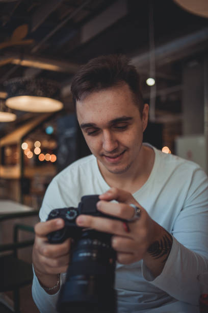 istock A man taking pictures with a camera in a cafe 1427336330