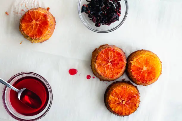 Upside Down Blood Orange, Hibiscus and Polenta Cakes: Mini cakes soaked in blood orange syrup and topped with a hibiscus glaze