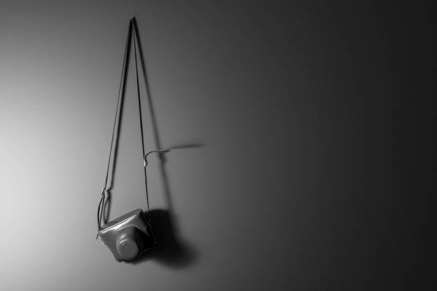 An old film camera hanging on a wall. Black and white. Retro style. copy space