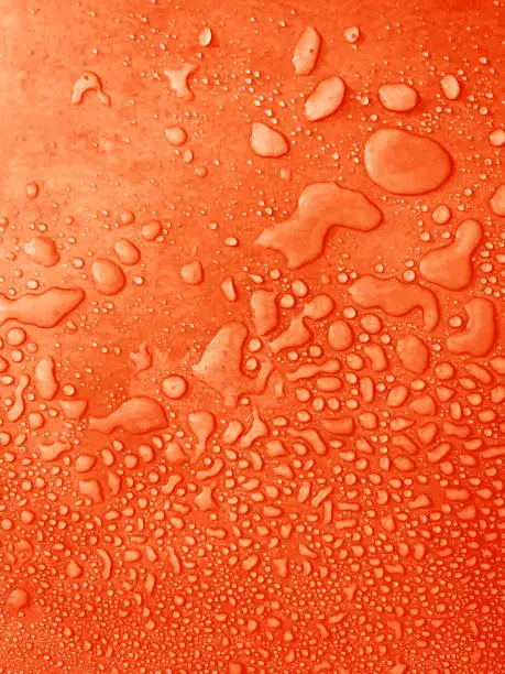 Photo of water drops of different sizes on a orange surface, drops texture, rain on orange tile, rain texture, red refreshing background, amber wet textured, fresh orange