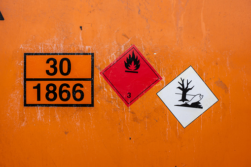 Gothenburg, Sweden - July 24 2022: Orange universal tank container marked UN 30 1866 Resin Solution flammable.