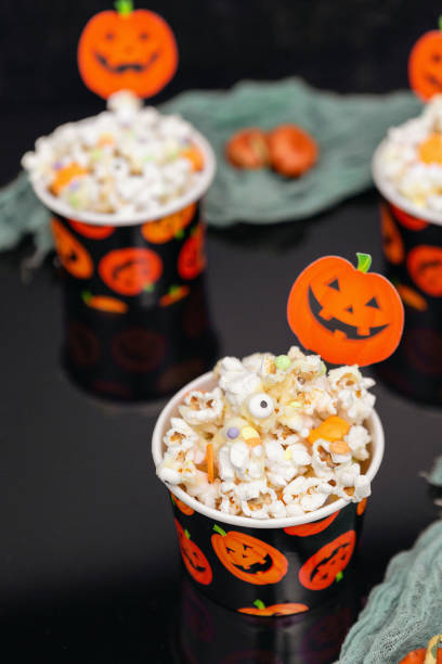 istock Three Paper Halloween Cups Filled with Popcorn with Halloween Sprinkles 1427342988