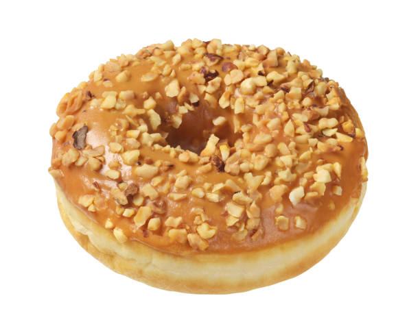 istock Caramel brown donut with nuts isolated on white. 1427344989