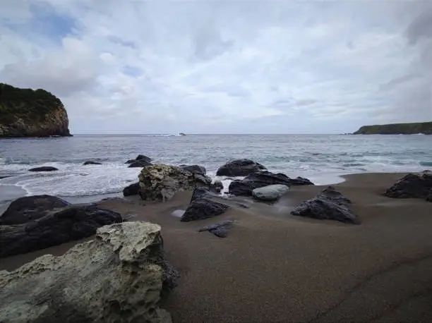 Photo of Black sand beach on flores volcanic island at the azores, Portugal