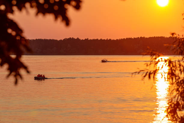 istock A boat pulls a person over the waves on a wakeboard. Wakeboarding at sunset 1427347770