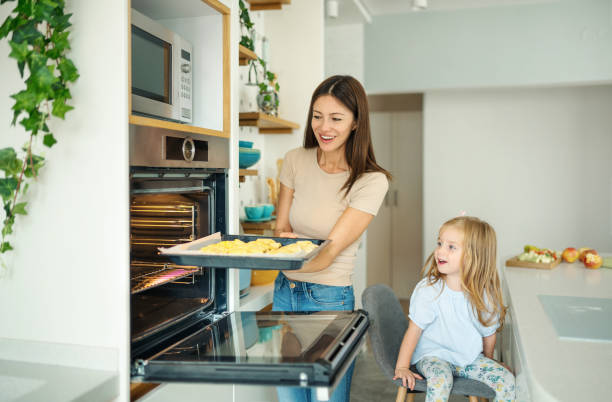 istock Young family baking cookies at home. 1427348850