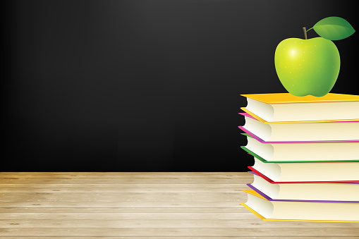 Book with green apple on wood background and education concept, back to school.