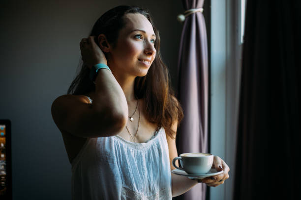 istock Beautiful woman relaxing and drinking coffee latte 1427351074