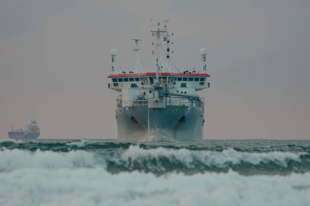 large industrial ship in the middle of the sea during a surf and travel week experience in Somo, Cantabria (Spain)