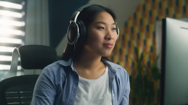 istock Asian woman in headset working on pc 1427359471