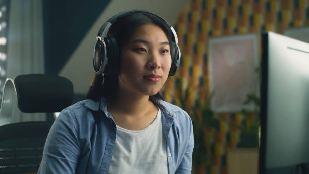 istock Woman in headphones browsing internet 1427359659