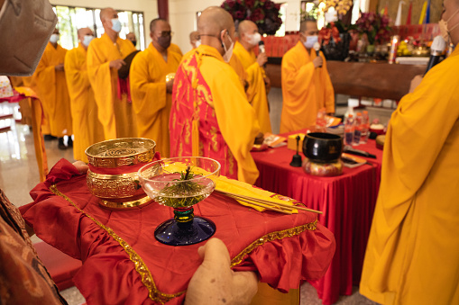 Bandung, Indonesia - January 8, 2022 : The monks meet at the altar o pray together with the congregation inside the Buddha altar