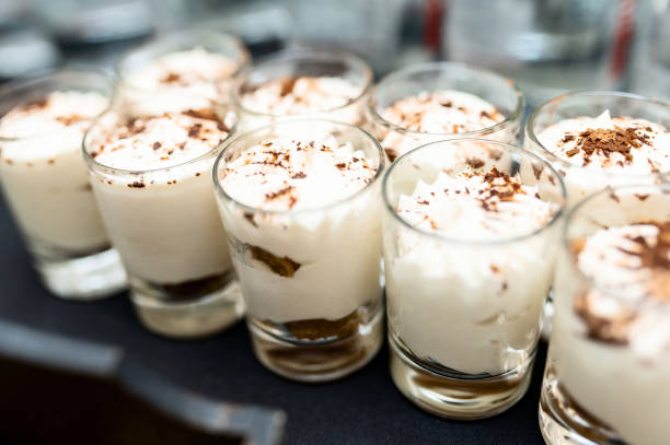 istock Three glasses of crumbled chocolate chip cookies and cheesecake parfaits against a rustic background. Extreme shallow depth of field with selective focus on dessert in front. 1427361669