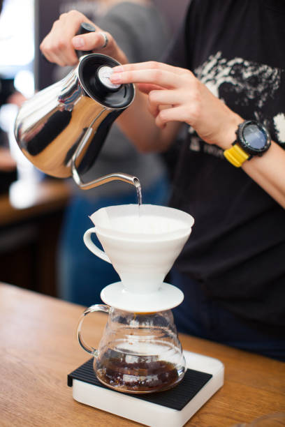 istock barista pours water from the kettle 1427361772