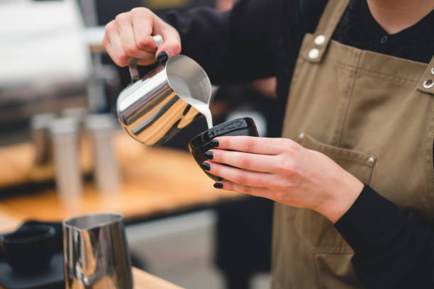 istock barista pours milk into a cup 1427361872