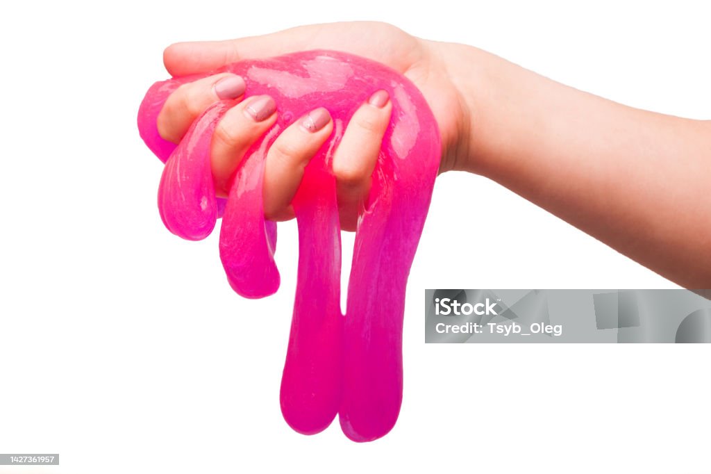 a toy for children mucus and liquid flowing on hand on a white background Slimy Stock Photo