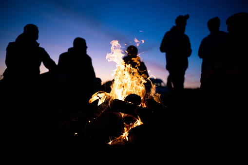 Rignat, France - June 23, 2012: back view of group of people, looking a great fire, gathered for the feast of St. John, bonfires lit on Midsummer Night