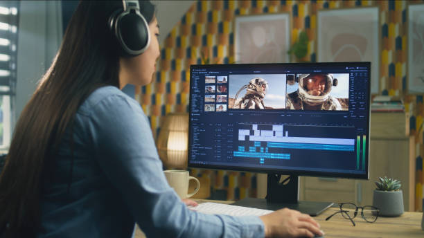 istock Woman in headphones editing video on pc 1427362683