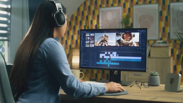 istock Woman in headphones editing video on pc 1427362944