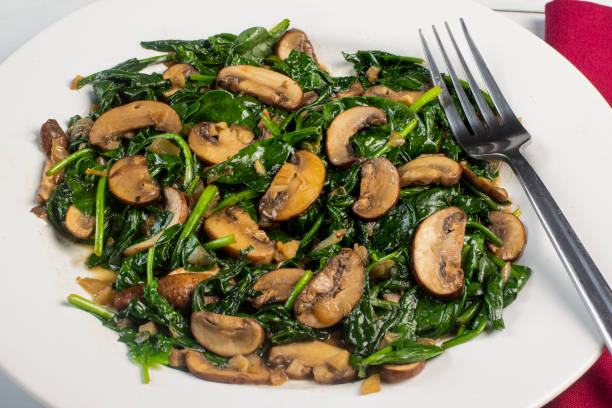 istock plate of sauteed spinach and mushrooms, 1427366593