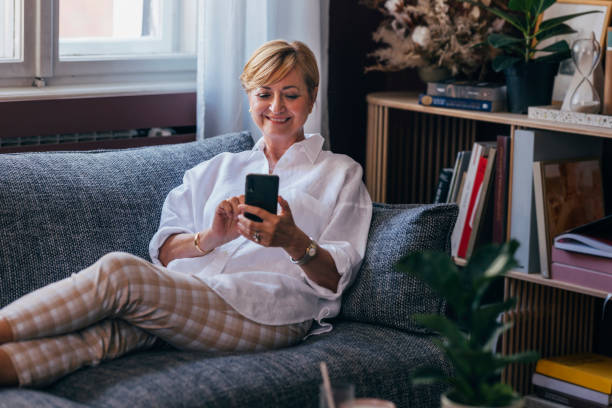istock A Happy Beautiful Senior Businesswoman Calling Somebody Using He 1427370062