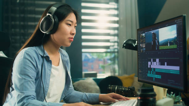Female editor working on video remotely Female asian freelancer editing video for customer or travel blogger in program on computer while sitting at the table and working at home female film editor stock pictures, royalty-free photos & images