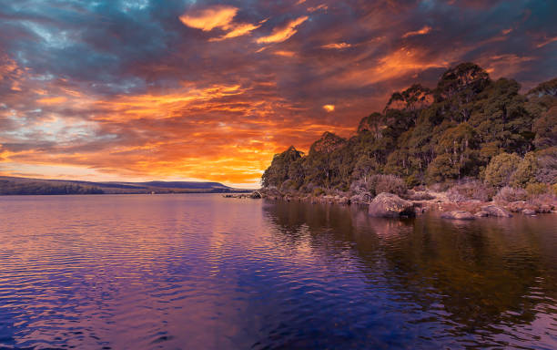 istock A spectacular cloudy colourful sunset sky is reflected and highlighted in the water and landscape background.. 1427372017