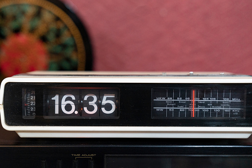 Older Digital Clock Radio Sitting on Wood Table