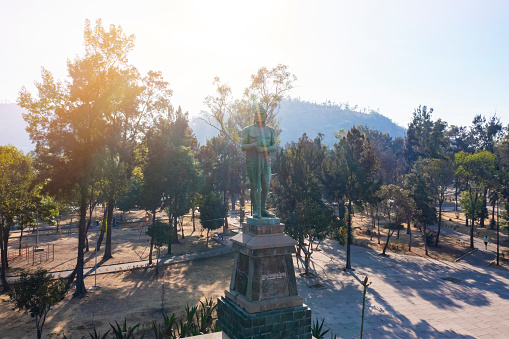 Aerial tour alongside the famous representative statues of the Indios Verdes public transit station north of Mexico City on a quiet morning