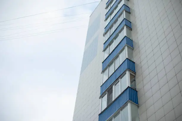 Photo of Building has blue balconies. Modern house in city.