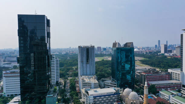 istock Futuristic design skyscraper. Modern architecture scrapper building on Thamrin Street in Jakarta 1427390389