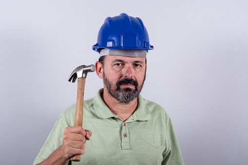 Portrait of 60 years old professional heavy industry engineer/worker wearing hardhat