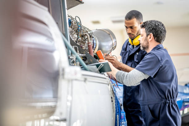 istock Aviation mechanics working in helicopter hangar, medium shot 1427393997