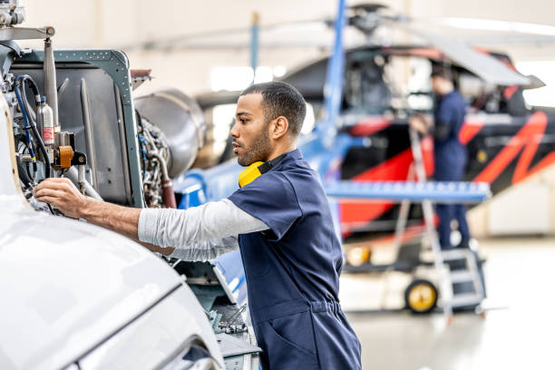 istock Airplane mechanics working in helicopter hangar 1427394003