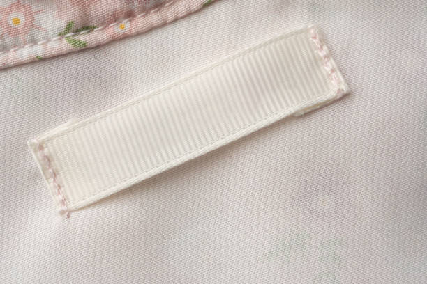 istock Blank laundry care clothes label on fabric texture background 1427394124