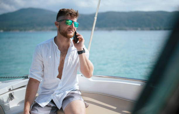 istock Man on boat talking on phone. 1427396868