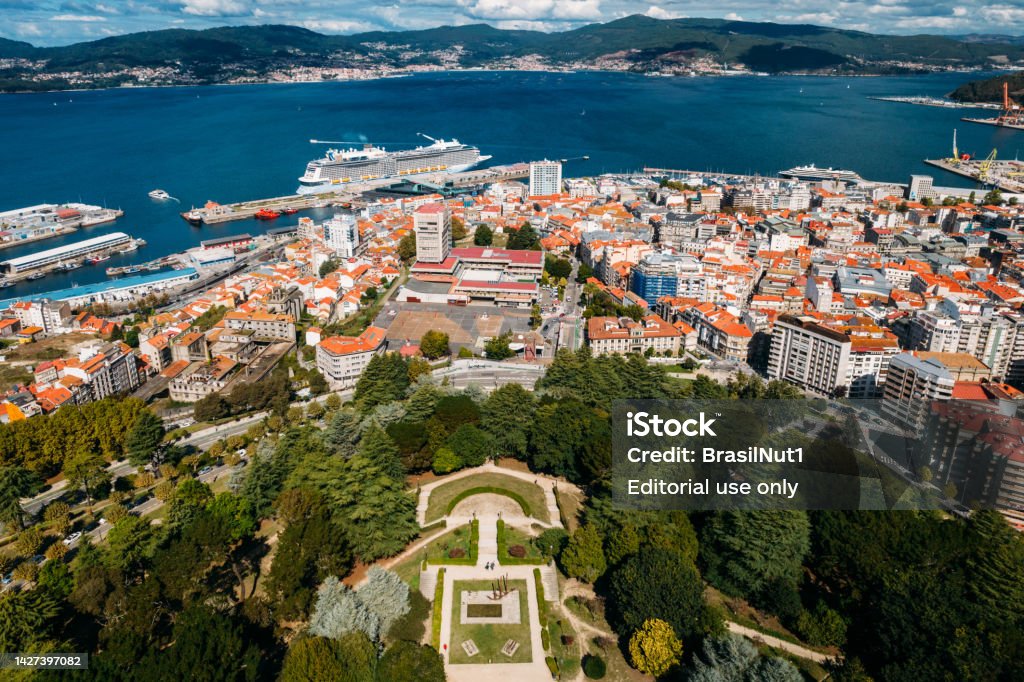 Boats and giant transatlantic cruise ship moored in the port of Vigo, Galicia, Spain Vigo, Spain - September 25, 2022: Boats and giant transatlantic cruise ship moored in the port of Vigo, Galicia, Spain with Monte do Castro in the foreground Vigo Stock Photo