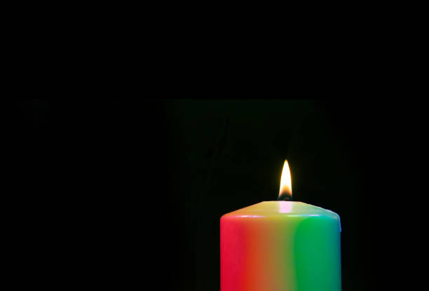 istock Burning candle with rainbow colored wax 1427407647