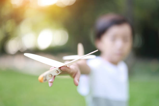 istock Young boy playing with airplane toy 1427409482