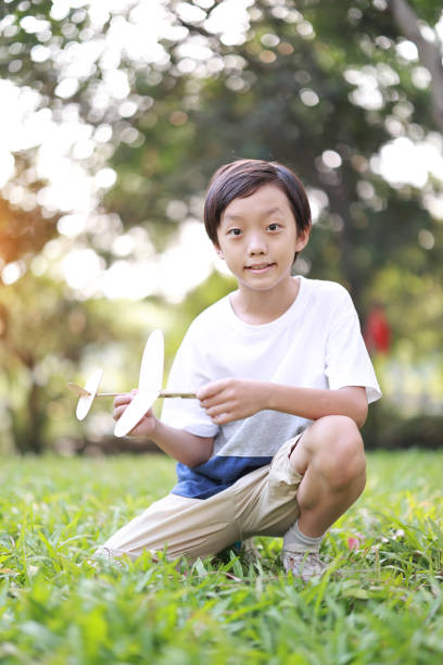 istock Young boy playing with airplane toy 1427409975