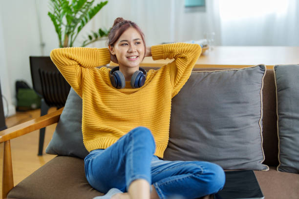 istock Portrait of a young Asian woman using a computer on the sofa 1427414381